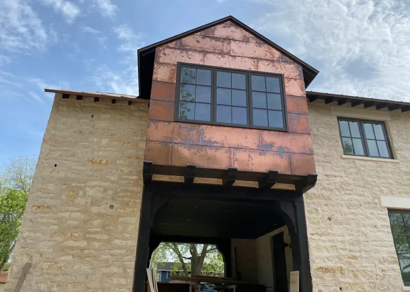 Copper metal panel facade on a stone building for Skylight Installation in DeLand